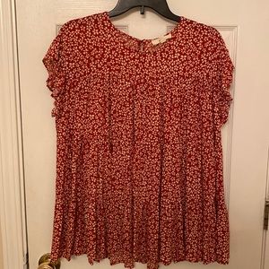 Red and cream babydoll style, flowy, short sleeve blouse.